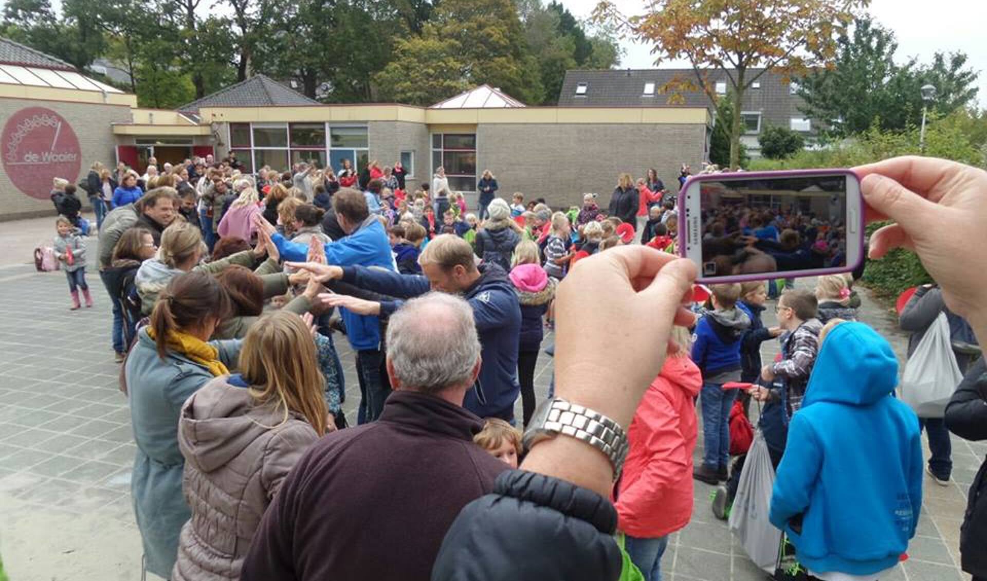 Leerlingen nemen in oktober 2015 afscheid van het oude schoolgebouw van de Waaier aan de Geestlaan in Warmond. | Foto: archief