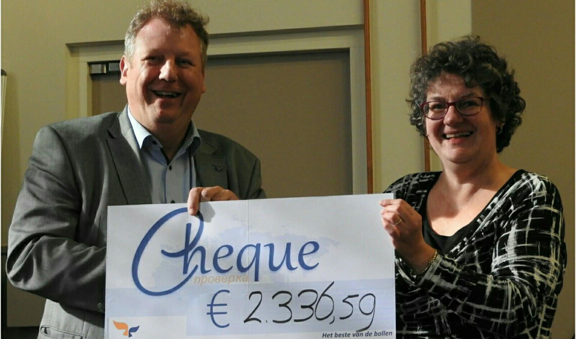 Marjan de Mooy overhandigt een mooie cheque aan directeur Geert-Jan Noorman van Friedensstimme. | Foto: Céline van Egmond