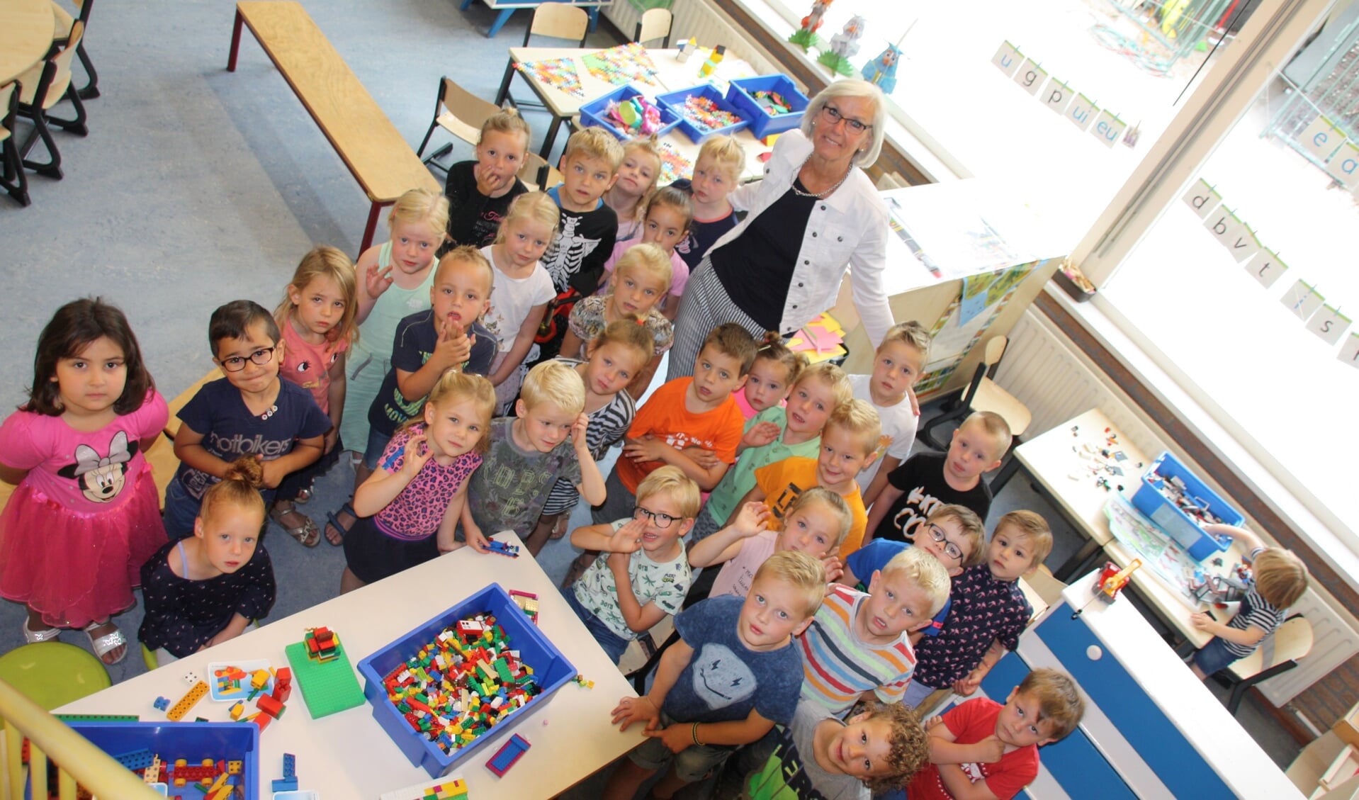 Ria Grimbergen te midden van 'haar' kleuters op De Giraf.