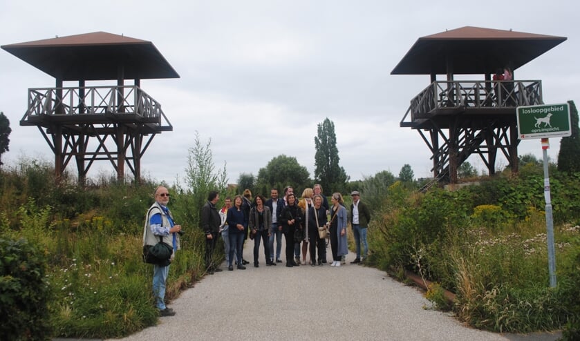 Een deelnemersgroep aan de vaartocht bewondert in het archeologisch park Matilo de nagebouwde wachttorens.