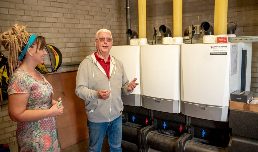 Voorzitter Luc de Beer en bestuurslid Leila van der Kaai van de VvE Merelstraat 186-304 bij de nieuwe HR-ketels.