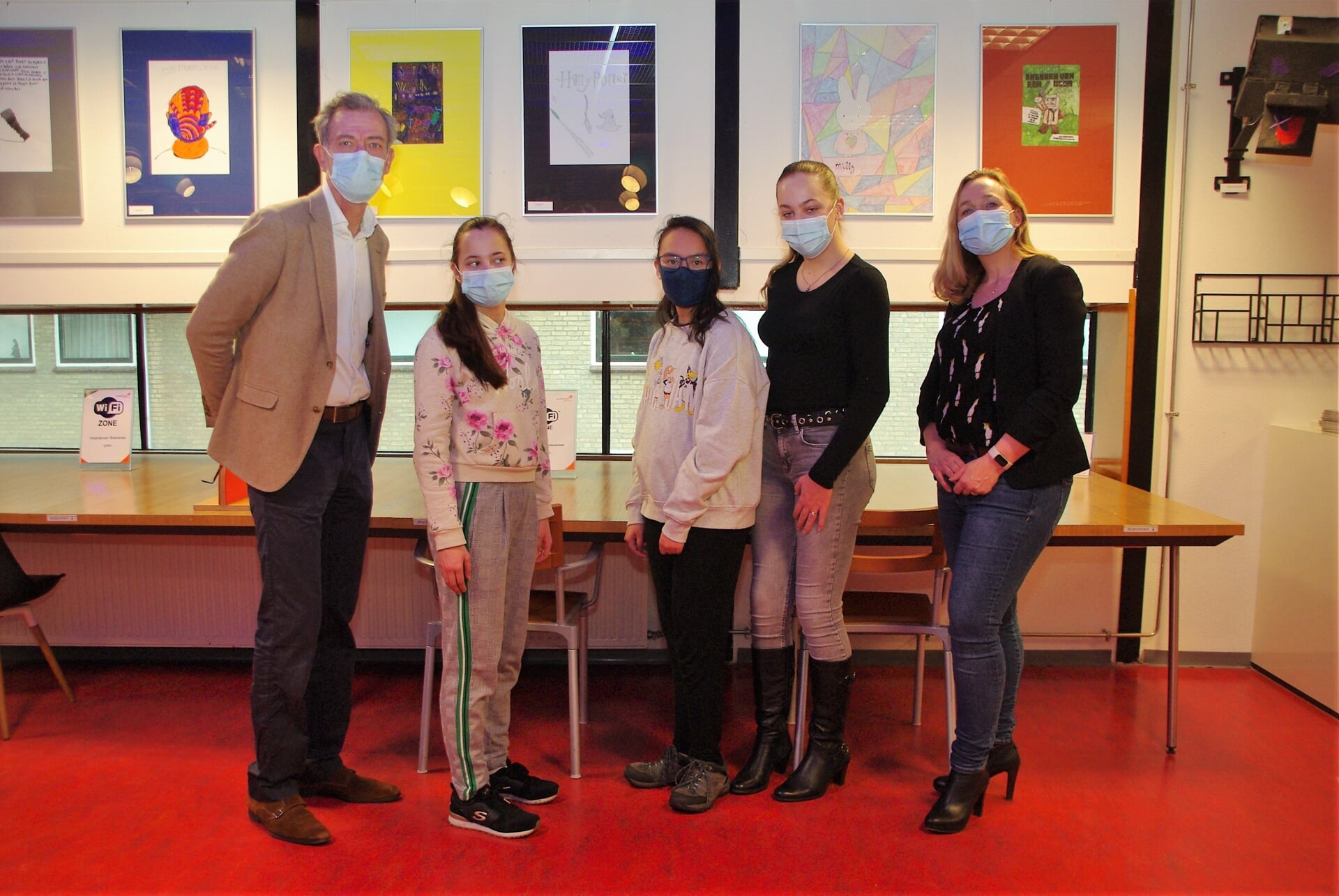Wethouder Matthijs Huizing (l) en directeur Anika Remerij (rechts, Kannerschool) poseren samen met drie leerlingen bij een aantal kunstwerken. | 