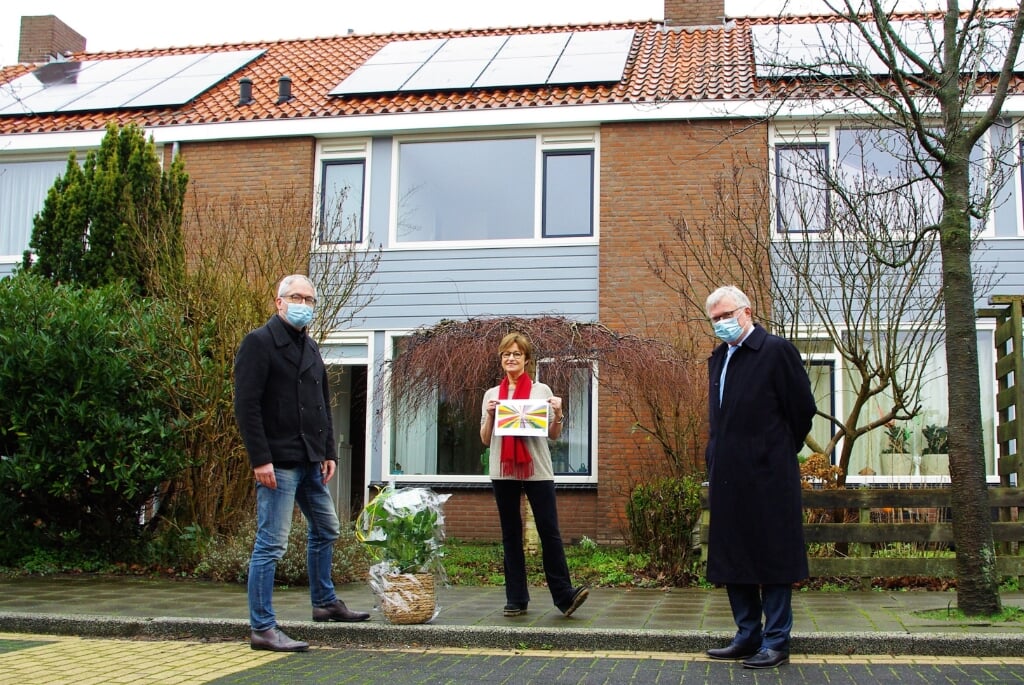 Lia Waaijer krijgt als huurder van het duizendste 'zonnepanelenhuis' attenties overhandigd. | Foto Willemien Timmers