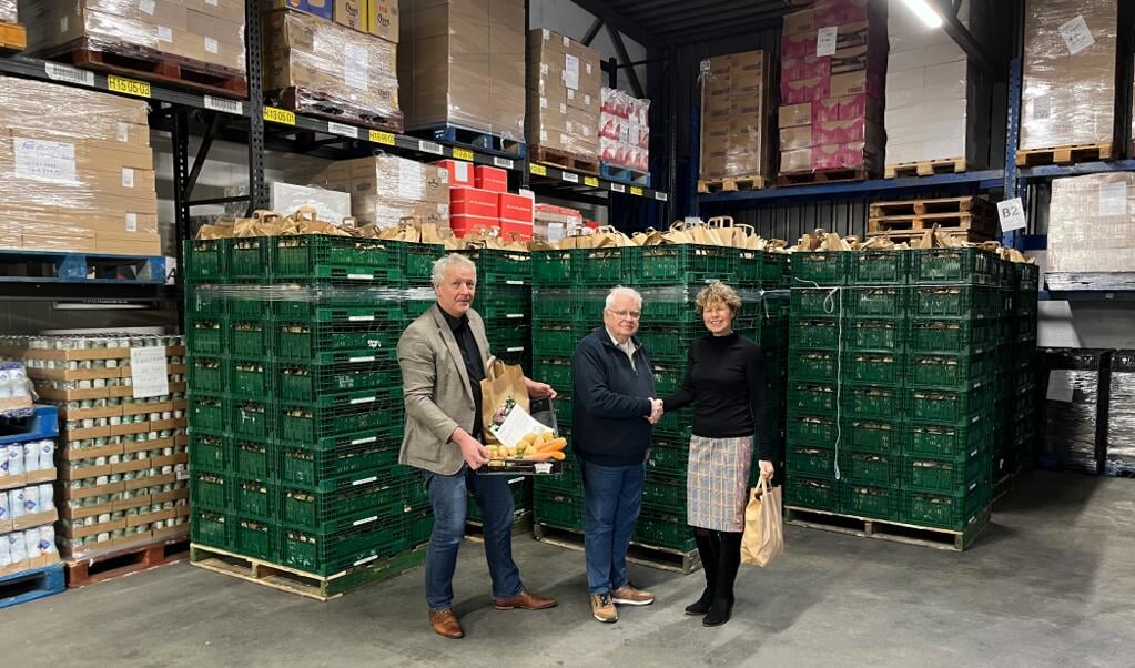 Uitreiking van voedselpakket door Corry Vlasma en Theo Jansma aan Harm de Jong van Voedselbanken Friesland.