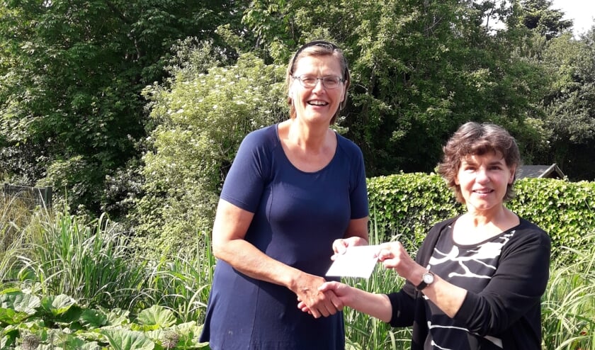 Karen Keijser overhandigt de opbrengst aan Lidwien de Ruiter van Hospice Texel.
