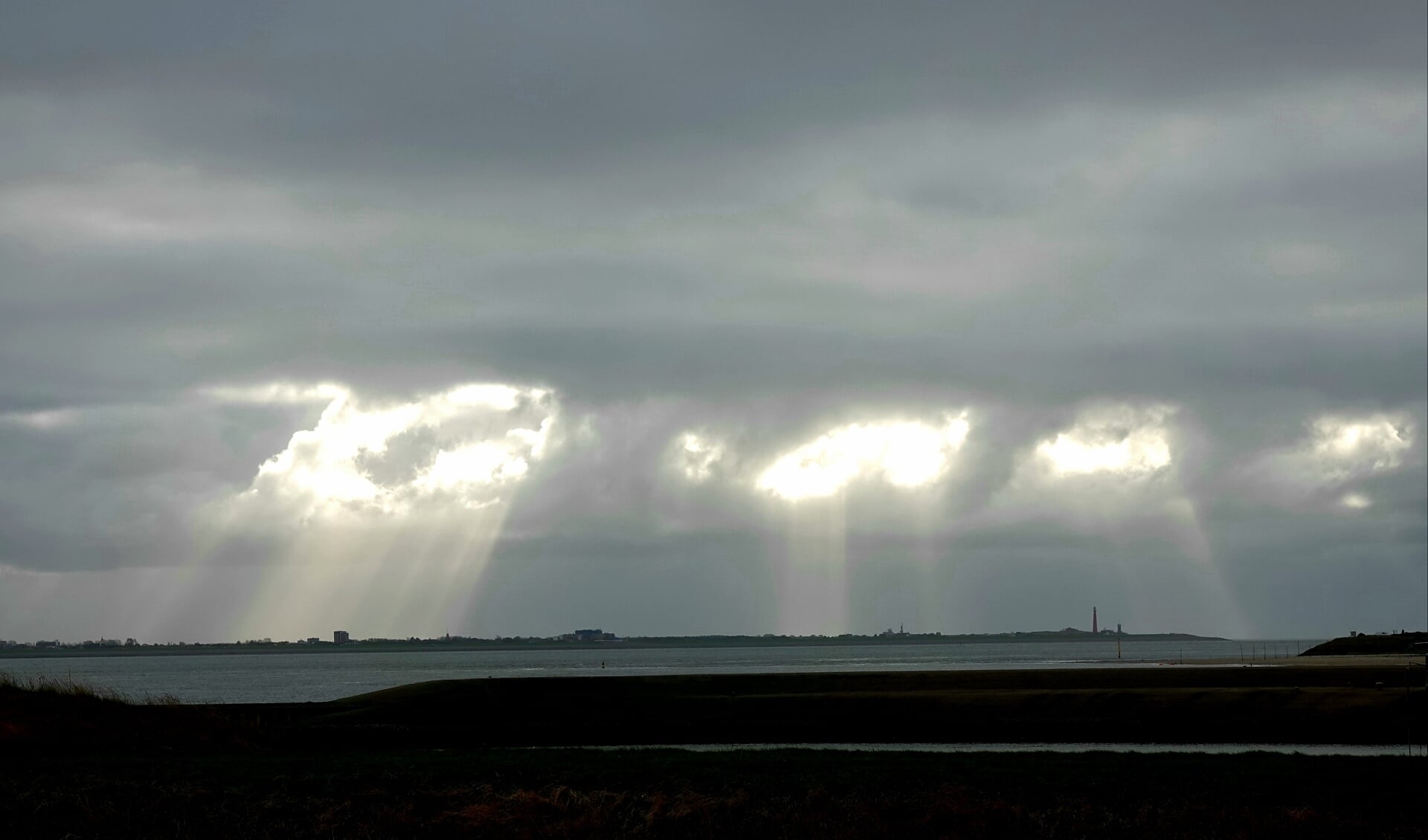 Zonnestralen boven Den Helder.