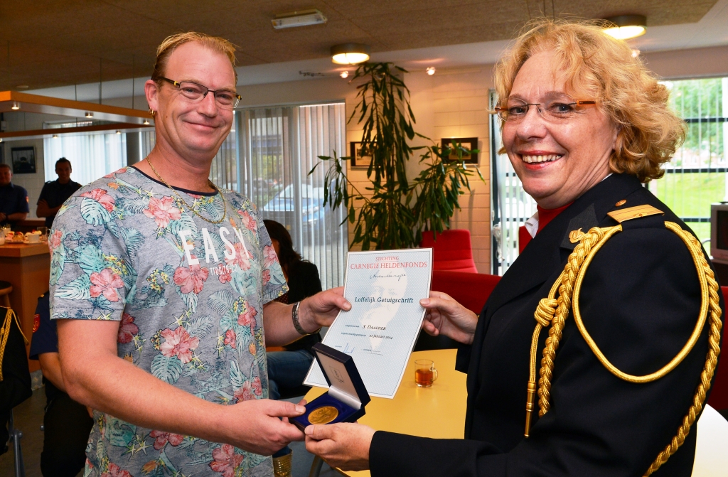 Simon Daalder ontvangt de onderscheiding van Hilda Raasing.