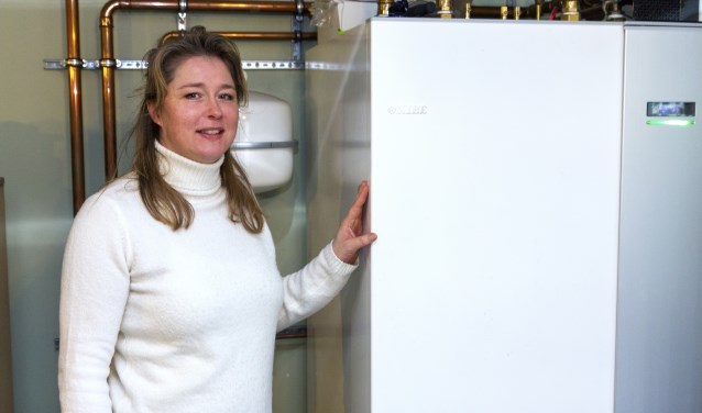 Jelly de Boer bij de warmtepomp in de eigen woning, aangeschaft dankzij de Investering Subsidie Duurzame Energie.