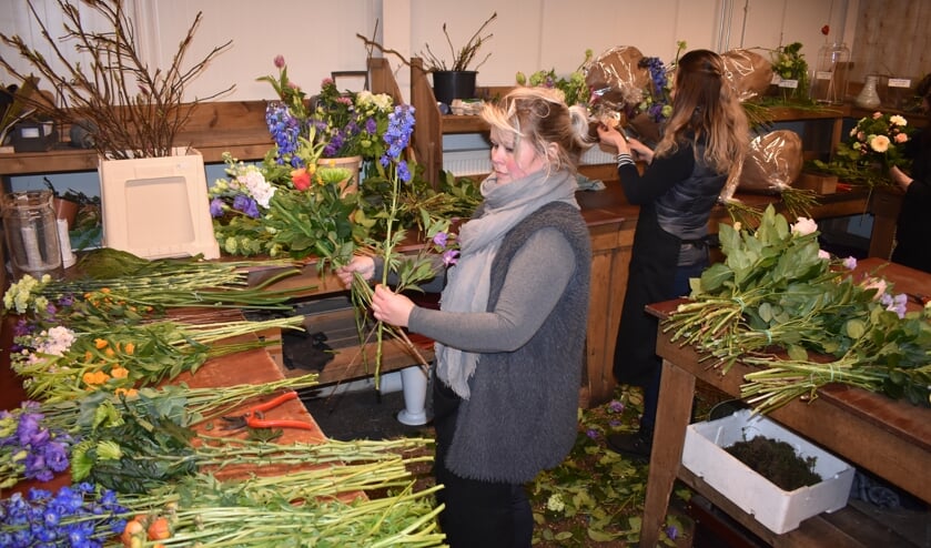 Alida Haisma (voorgrond) en haar medewerksters maken vele boeketten.