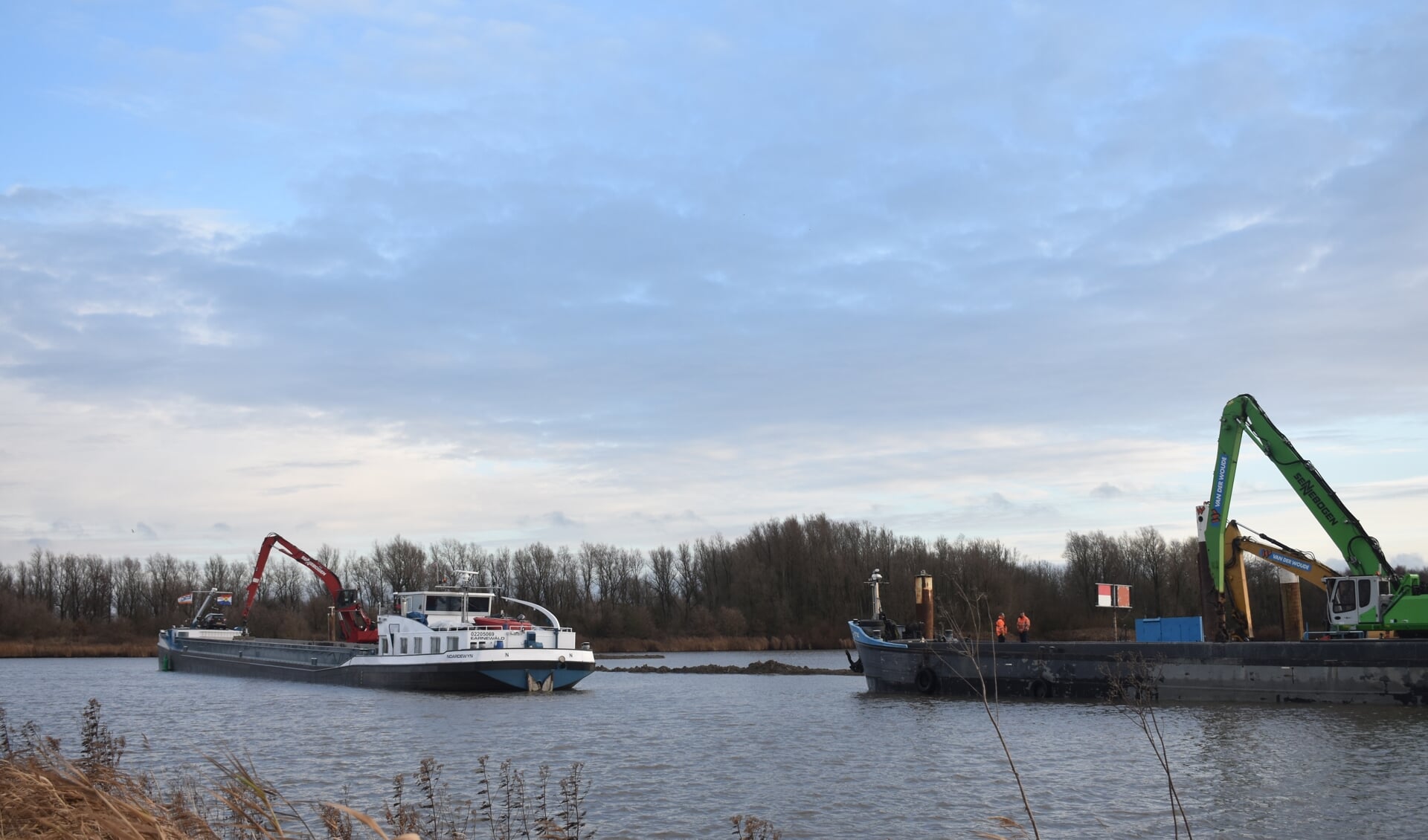 Vanuit het schip 'Noardewyn' (links) wordt grond geschept in het toekomstige 'plasdras'-gebied, aan de Wâldweikant van het Van Harinxmakanaal.