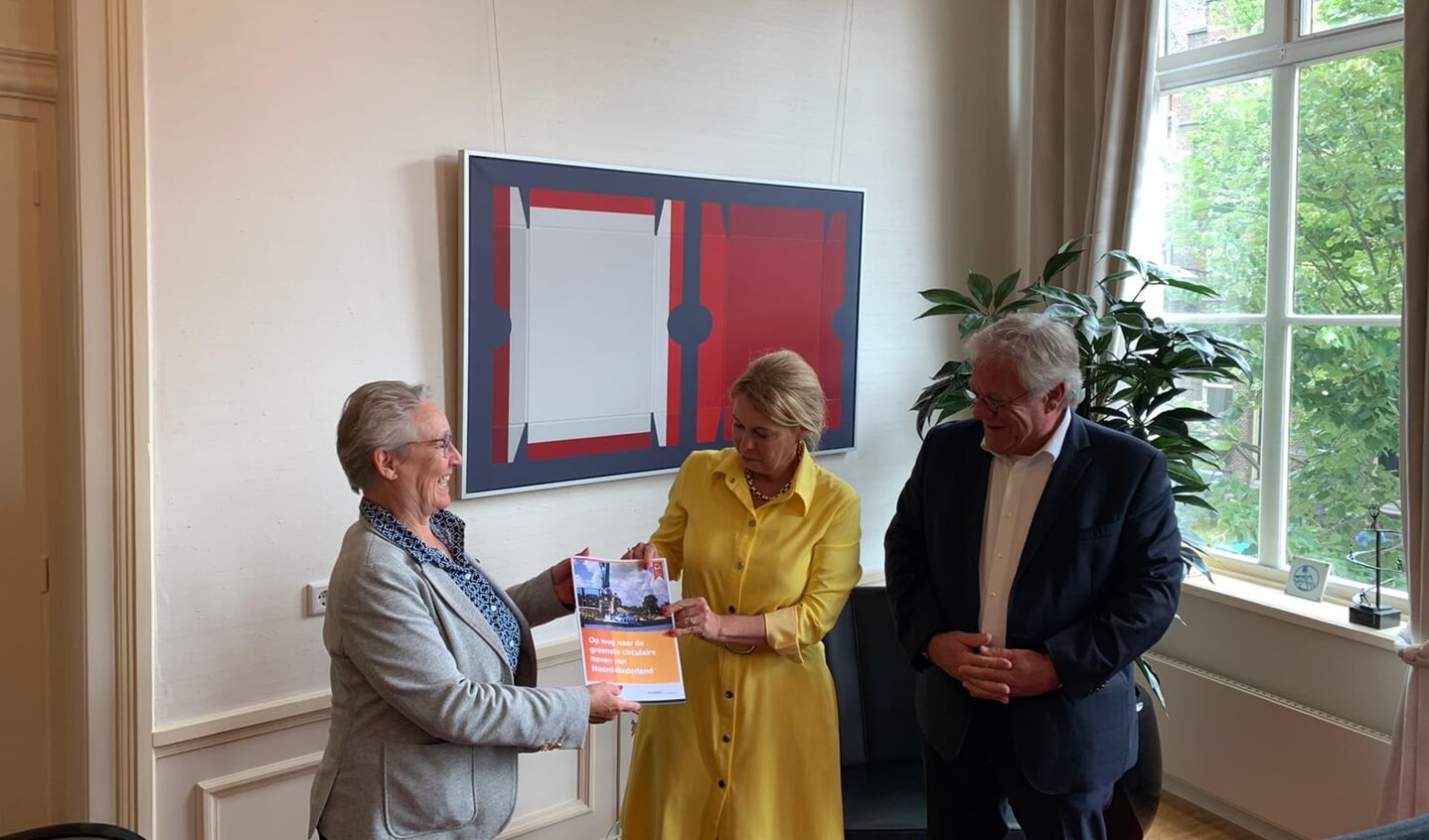 Gedeputeerde Avine Fokkens-Kelder (midden) neemt de brochure 'De groenste haven van Noord-Nederland' in ontvangst van de wethouders Maria le Roy en Robin Hartogh Heys van Smallingerland.