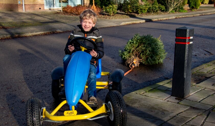 <p>Liam sleept de eerste boom met zijn skelter naar de inleverplek. Foto Marion Verhaaf</p>