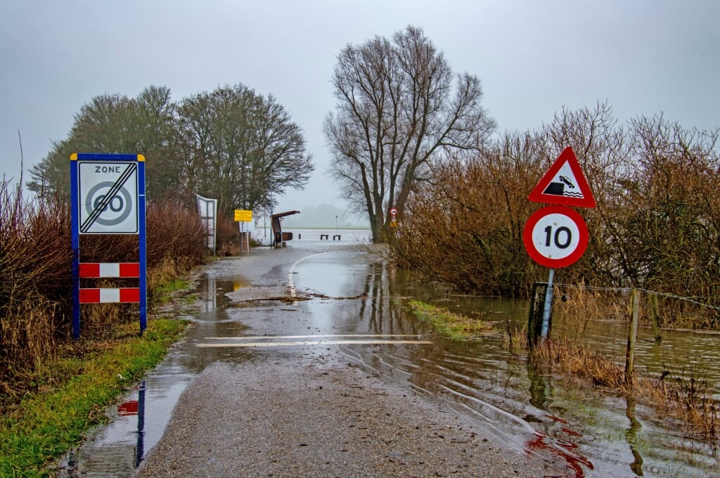 De weg richting de pont is overgenomen door de stijgende IJssel. Foto: Marion Verhaaf