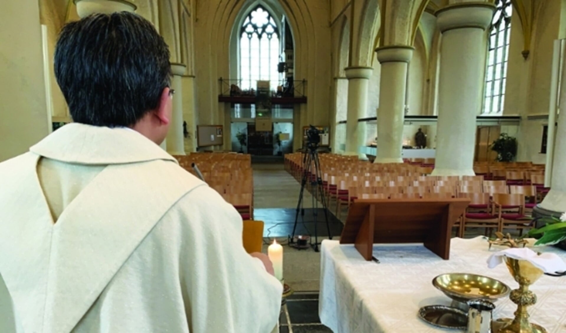 Pastoor Thanh Ta tijdens online viering in een lege kerk. (Foto: Lennart)