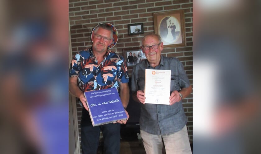 Koster Van Schaik (rechts) en kerkrentmeester Johan Hommerson bij het aanbieden van onder andere de oorkonde. (foto: Alexander Wieringa)