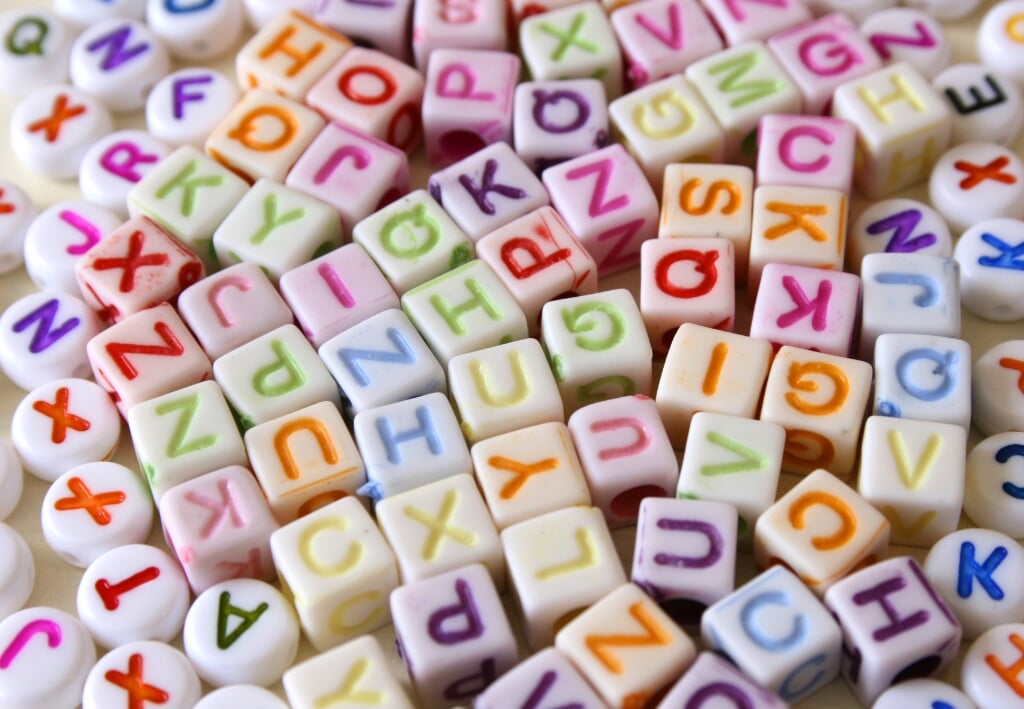 Small Colorful letters on different white shapes