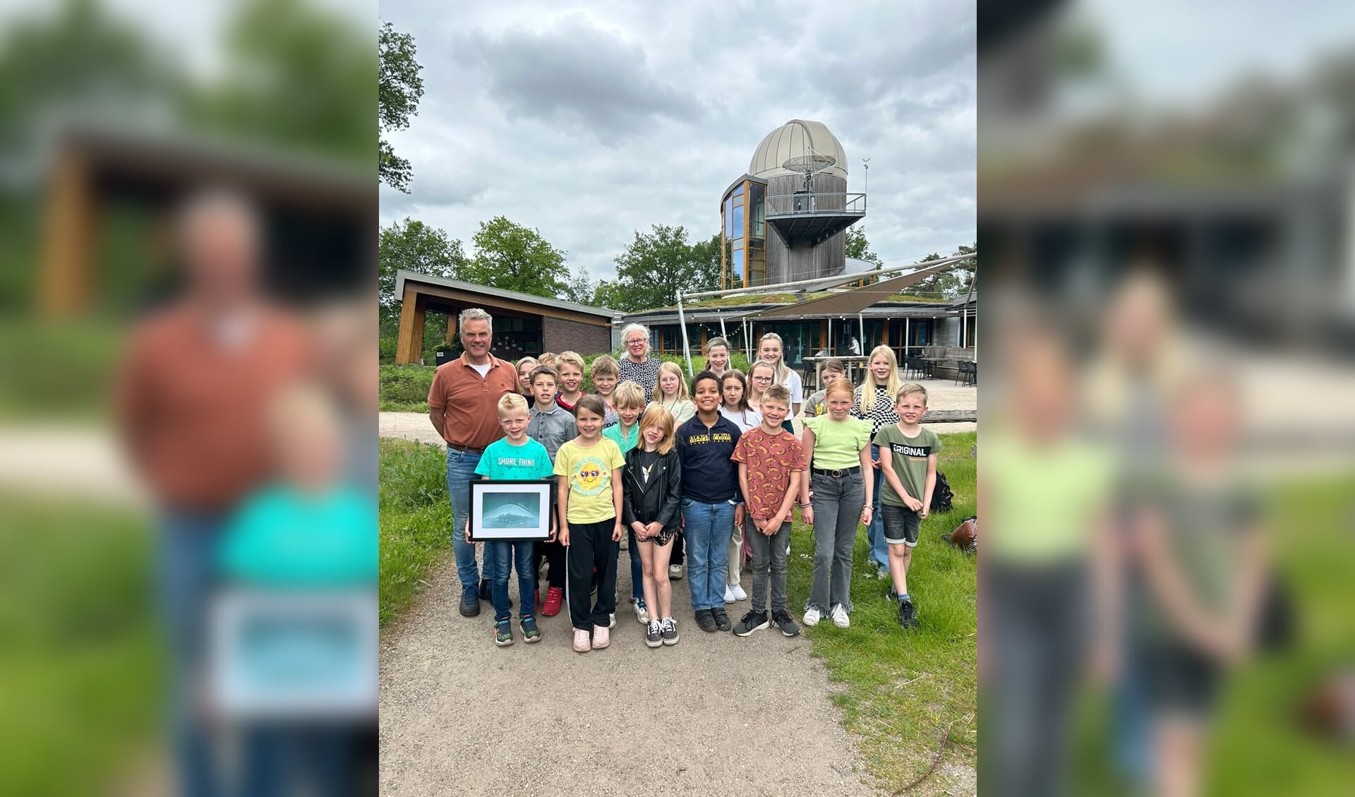 Op de foto de blije winnaars met hun ingelijste solargraphy bij de sterrenwacht.